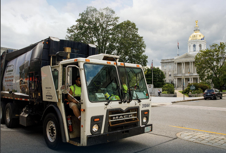 A Casella waste collection truck passes the State House in Concord, NH.